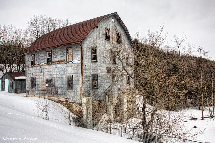 Bell’s Grist Mill A fantastic looking mill built in 1904. It is covered by a large number of rectangular metal plates, an unusual arrangement. The sign on the side says: Bell’s Grist Mill The original frame structure was established on this site by James Spink in the 1860?s. He later sold it to Richard bell who came to Utopia from Moneywood at 15 years to learn the milling trade. two sawmills located on the north side of Bear Creek just below the present dam site operated concurrently with th Bell’s Grist Mill A fantastic looking mill built in 1904. It is covered by a large number of rectangular metal plates, an unusual arrangement. The sign on the side says: Bell’s Grist Mill The original frame structure was established on this site by James Spink in the 1860?s. He later sold it to Richard bell who came to Utopia from Moneywood at 15 years to learn the milling trade. two sawmills located on the north side of Bear Creek just below the present dam site operated concurrently with th